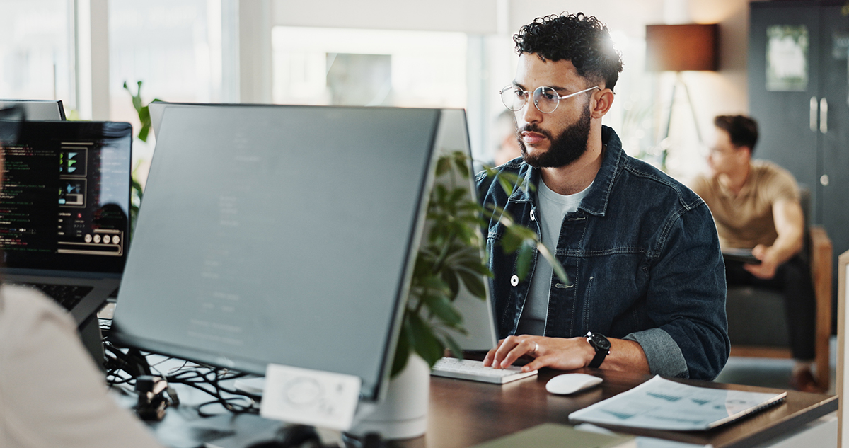 Computer engineering, programming and web development with man in creative workplace for design. Cybersecurity, system infrastructure an typing with employee person in office as website maintenance HR professional working on a computer managing internal requests and employee records with C2 ITSM.