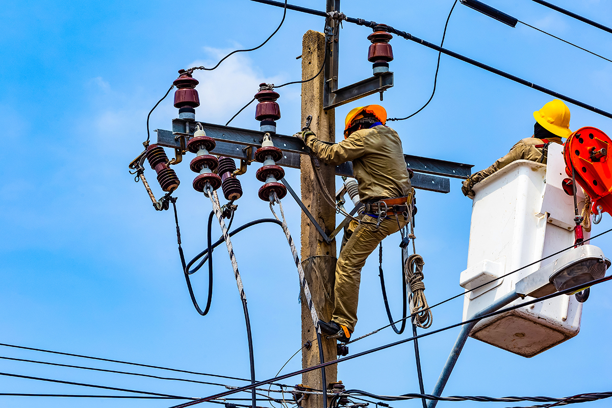 The electrical worker are repairing the electrical system Utility workers adjusting electrical lines on a pole, illustrating flexible and customizable change processes in different contexts.