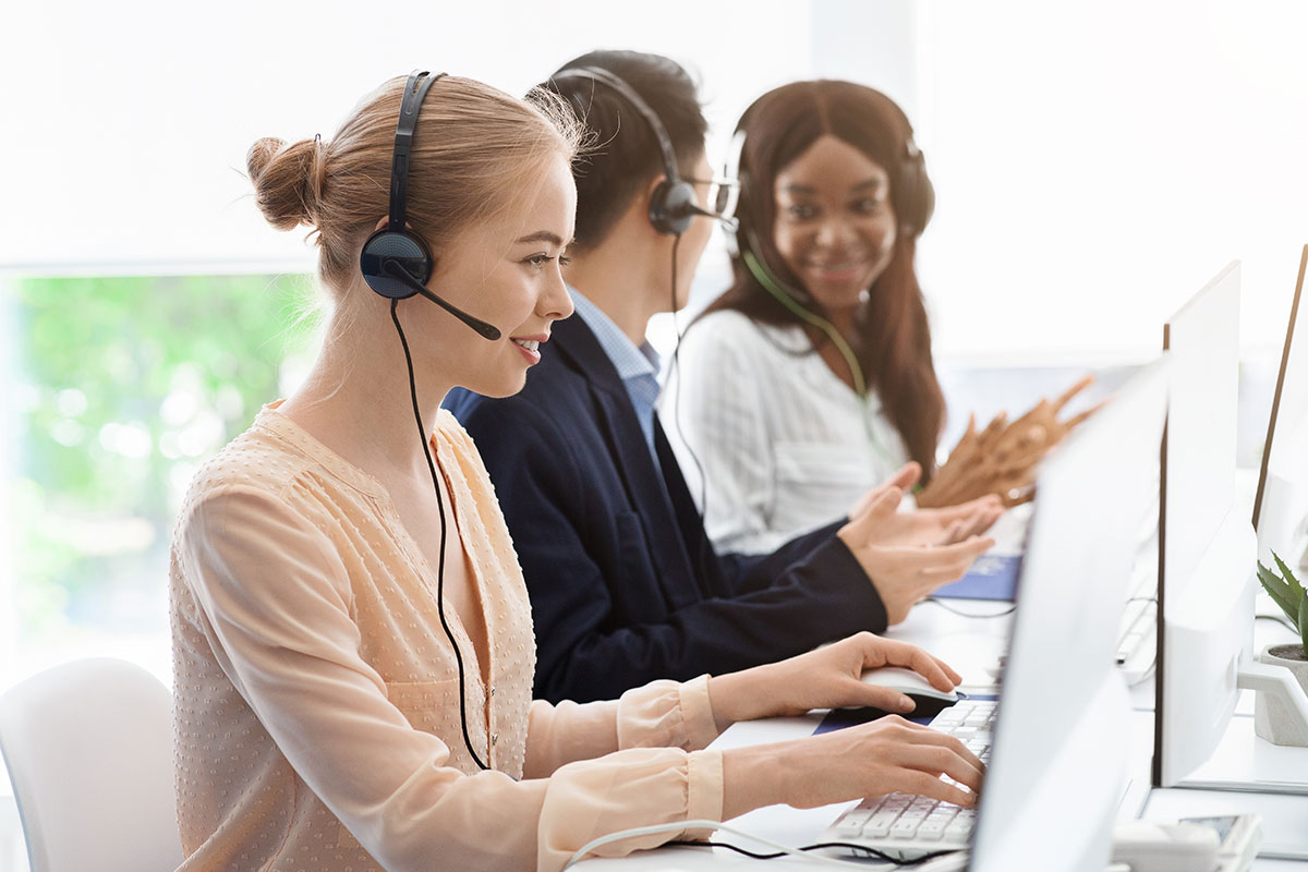 AdobeStock_359522579 Smiling IT support agents collaborating in a service centre – teamwork and request management with C2 ITSM.