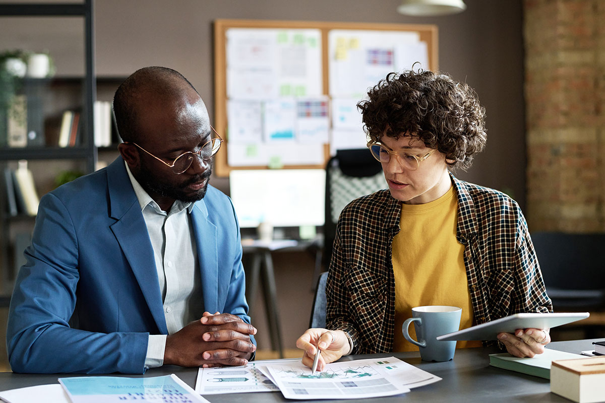 AdobeStock_508662584 Two IT professionals reviewing performance reports – measuring SLA results and continuous improvement with C2 ITSM.