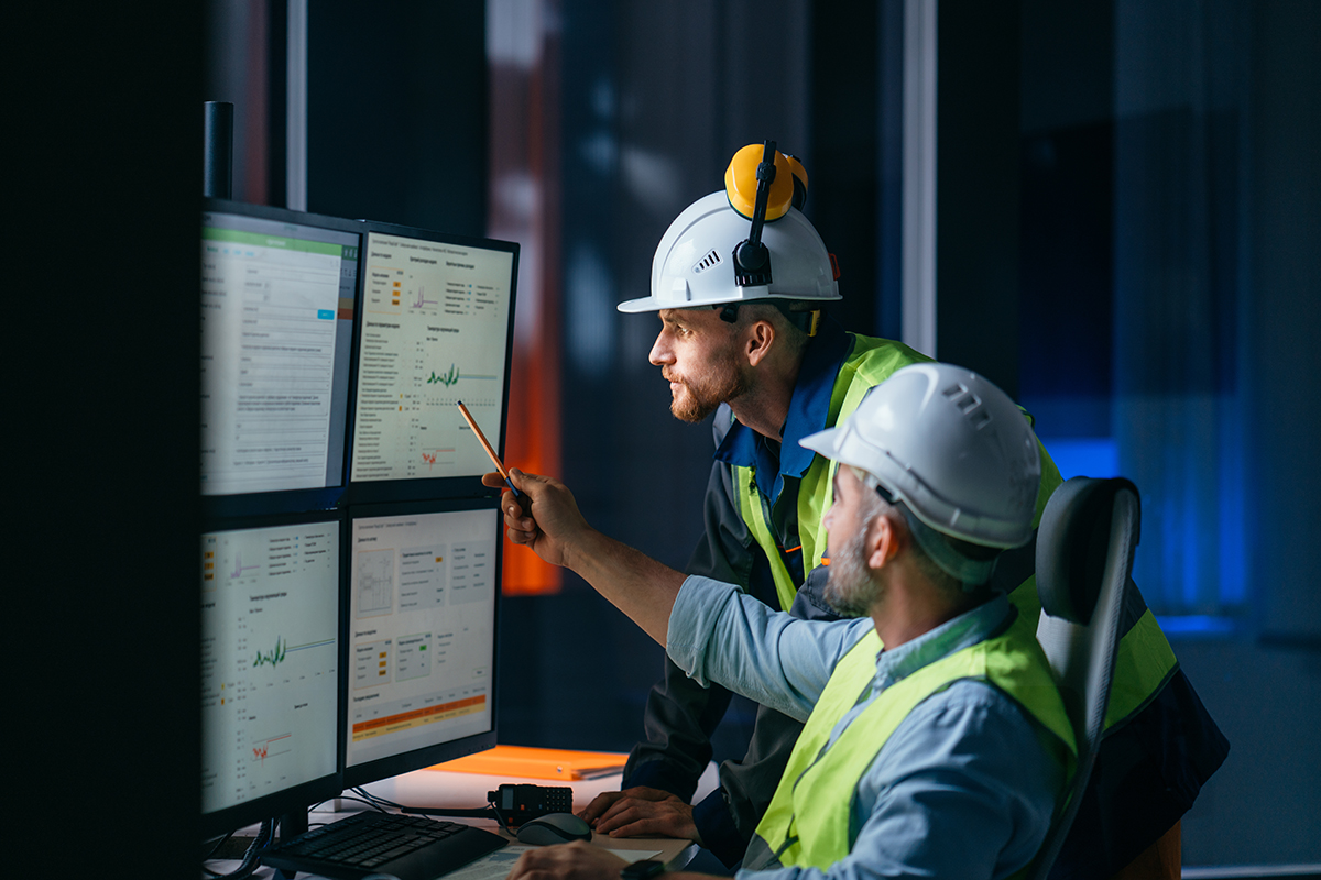 Group of operators control process on product line uses industry 4.0 and digital technology on modern factory. Two engineers follow assembly process uses SCADA system which AI technology and UI Managers using C2 ITSM performance reports to track SLAs, volumes, and resolution times.