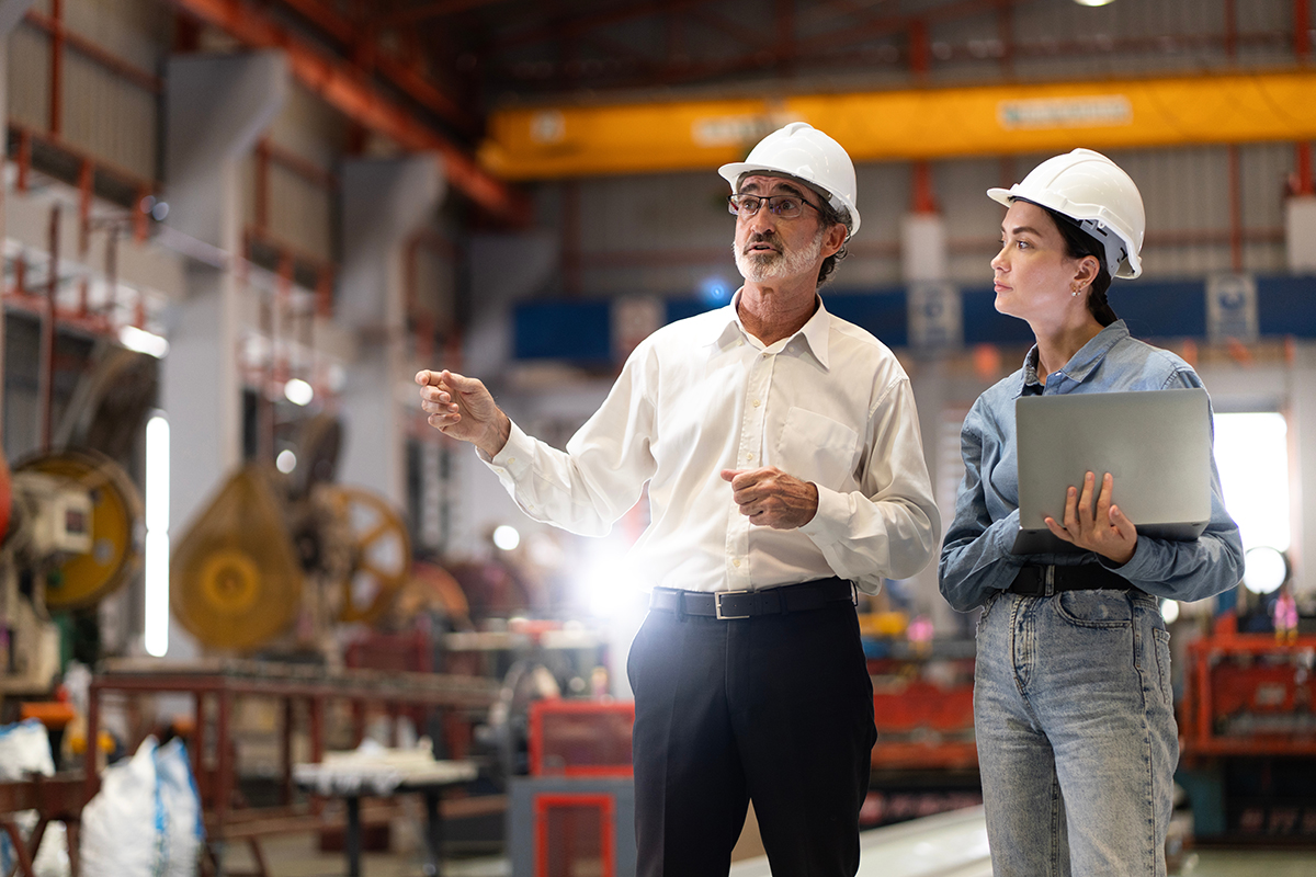 two professional engineer,worker,technician use clipboard discus Two IT managers reviewing equipment in a warehouse, illustrating proactive asset monitoring with threshold alerts.