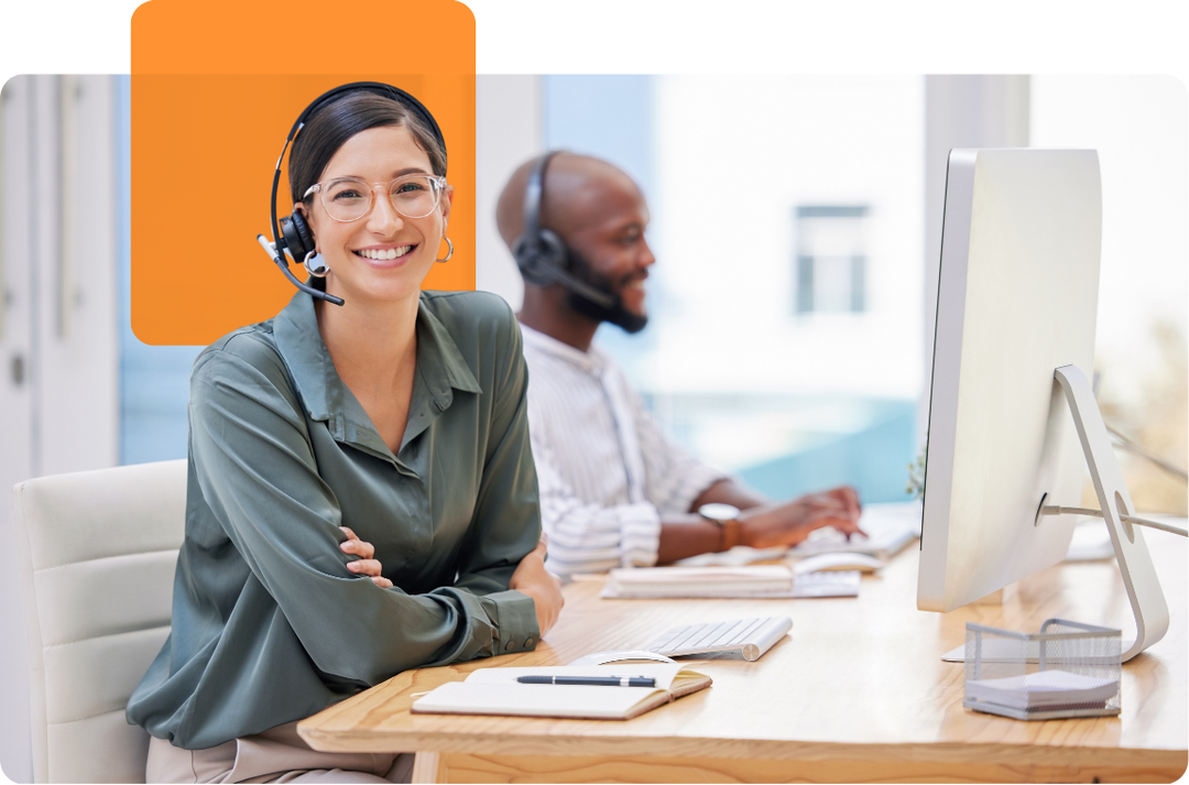 Home-Service-desk-agent Smiling IT support specialists providing customer assistance from a modern Canadian office, representing C2 ITSM’s friendly and responsive service.