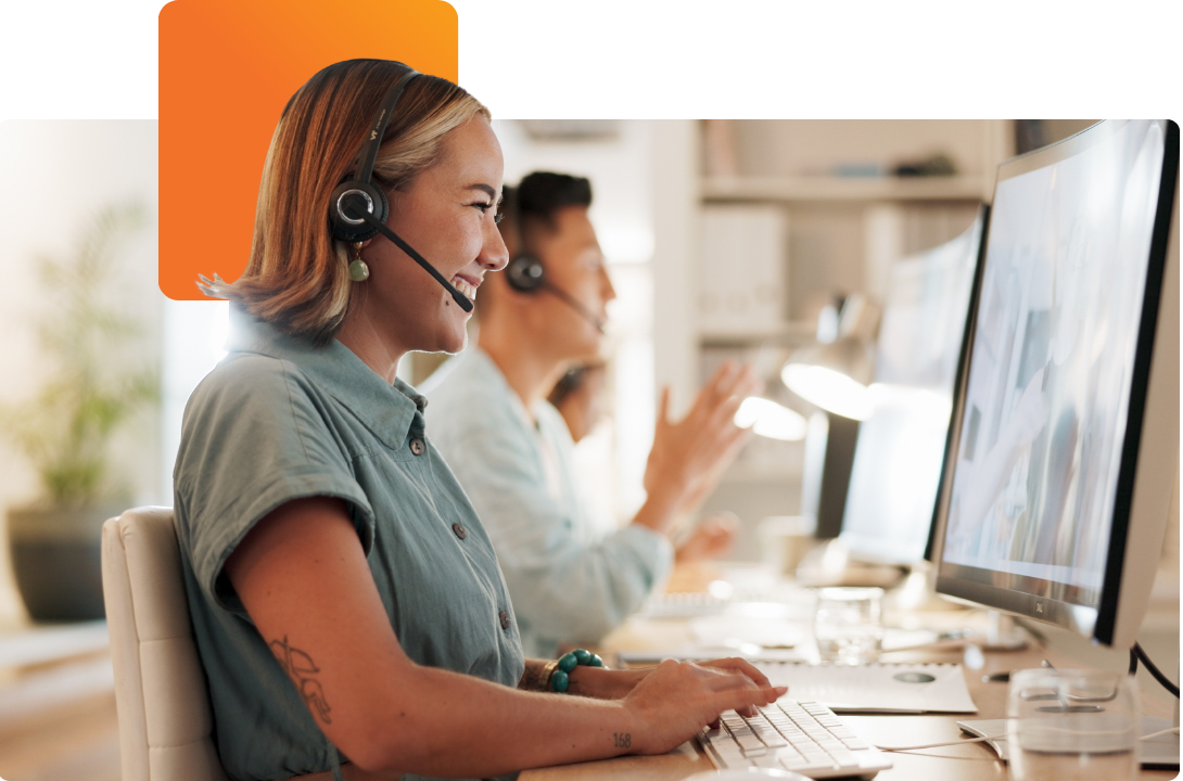 a-propos Customer support specialists working on computers in a bright office, representing C2 ITSM’s collaborative service management platform